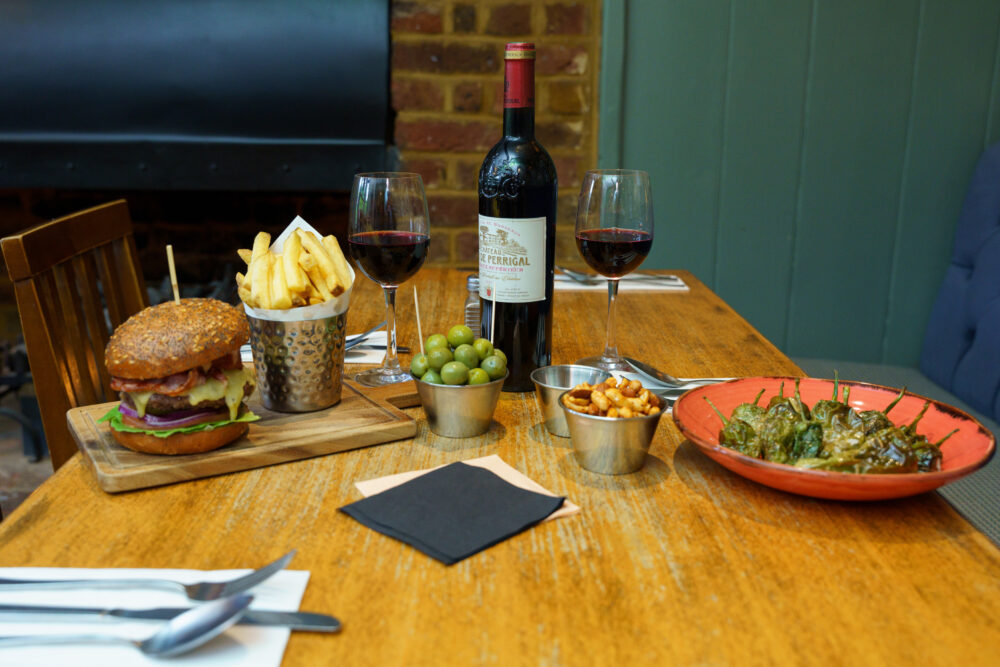 A tempting spread of cosy comfort food and a glass of rich red wine at The Orange Tree.